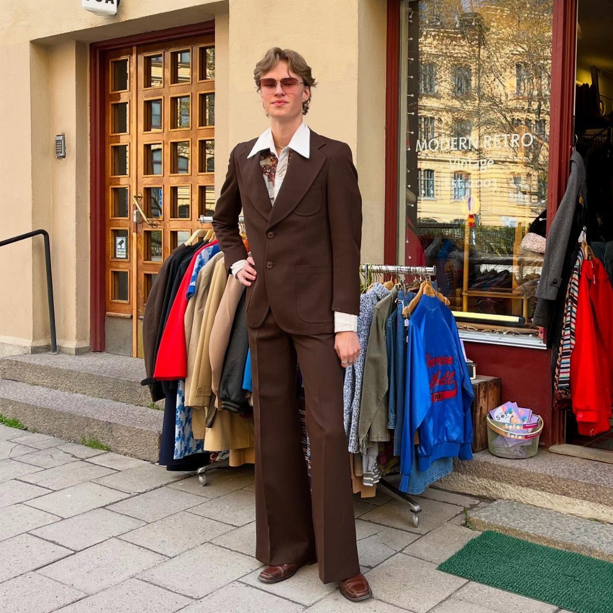 Man wearing a brown vintage leisure suit with wide lapels and flared trousers.