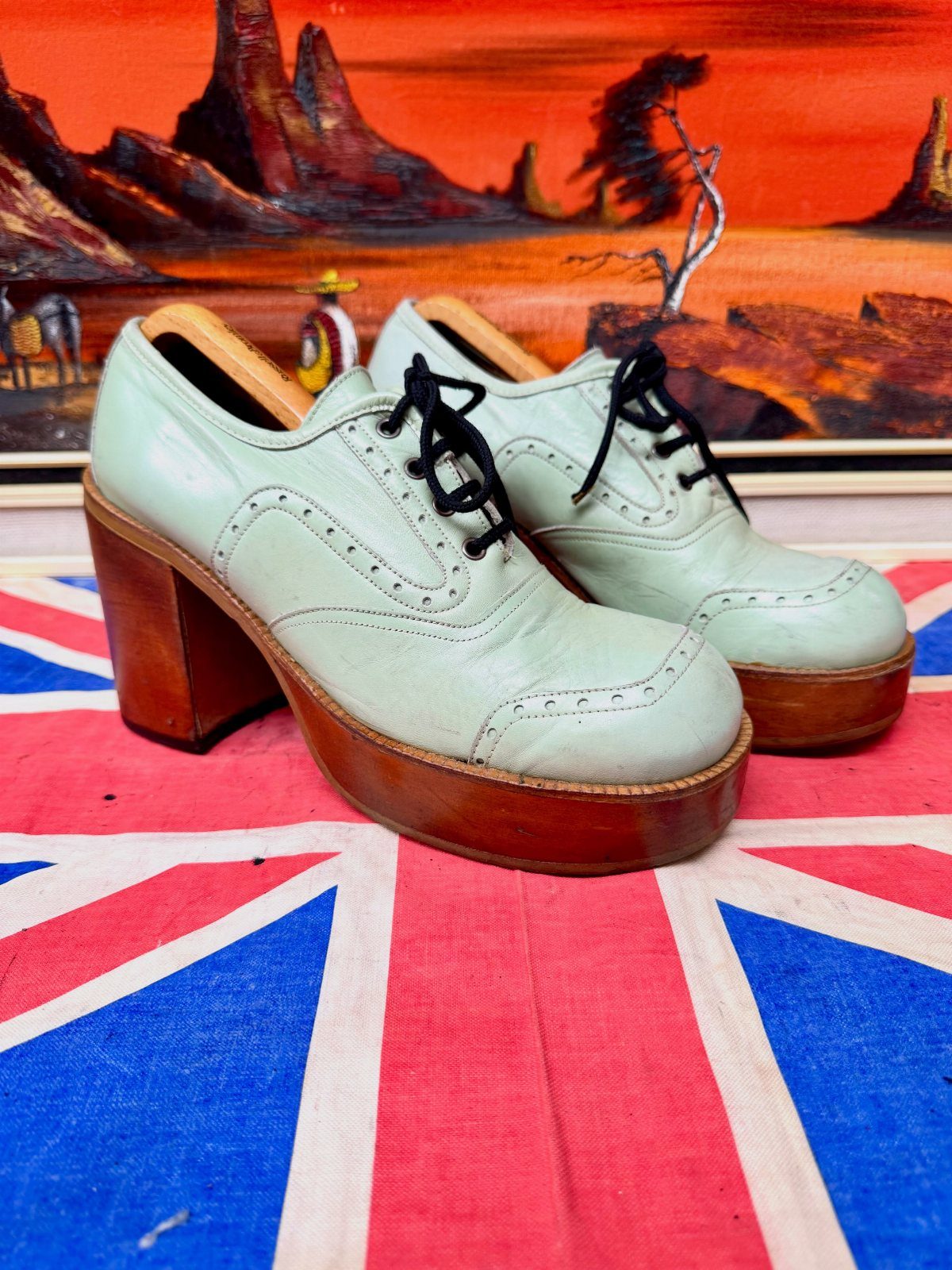 Mint green platform leather oxfords with brown wooden soles on a Union Jack flag.