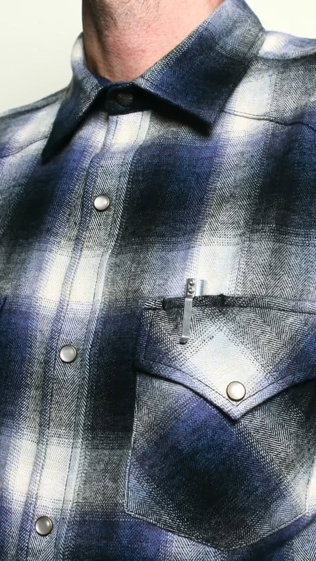 Blue and white plaid flannel shirt with snap buttons and a chest pocket.