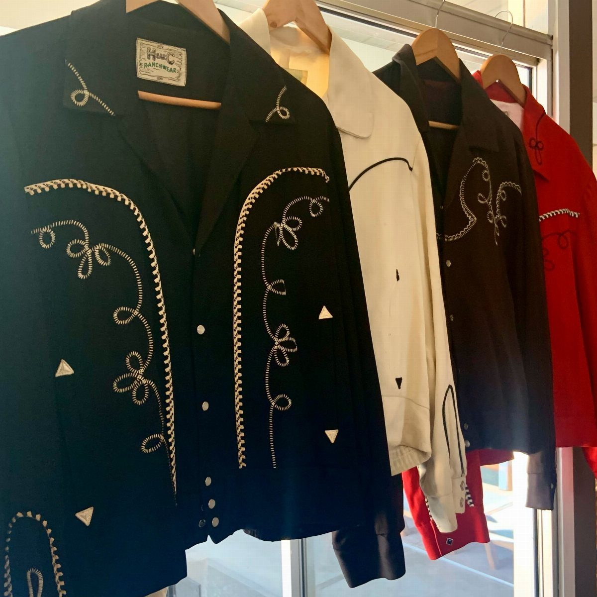 10 Images of 70's Men's Fashion from Flares to Fur Coats 7 Vintage western jackets in black, white, brown, and red with white decorative embroidery.
