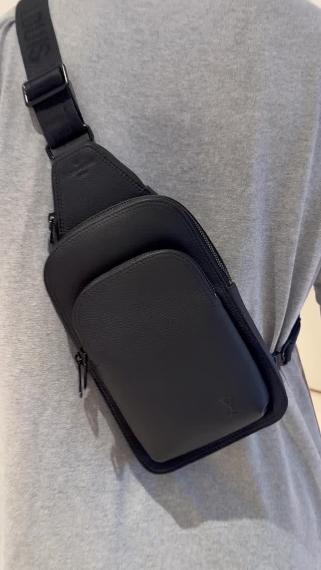 Men's Fashion Crossbody Bag: 6 Styles Worth Carrying 4 Black leather crossbody sling bag worn over a grey t-shirt.
