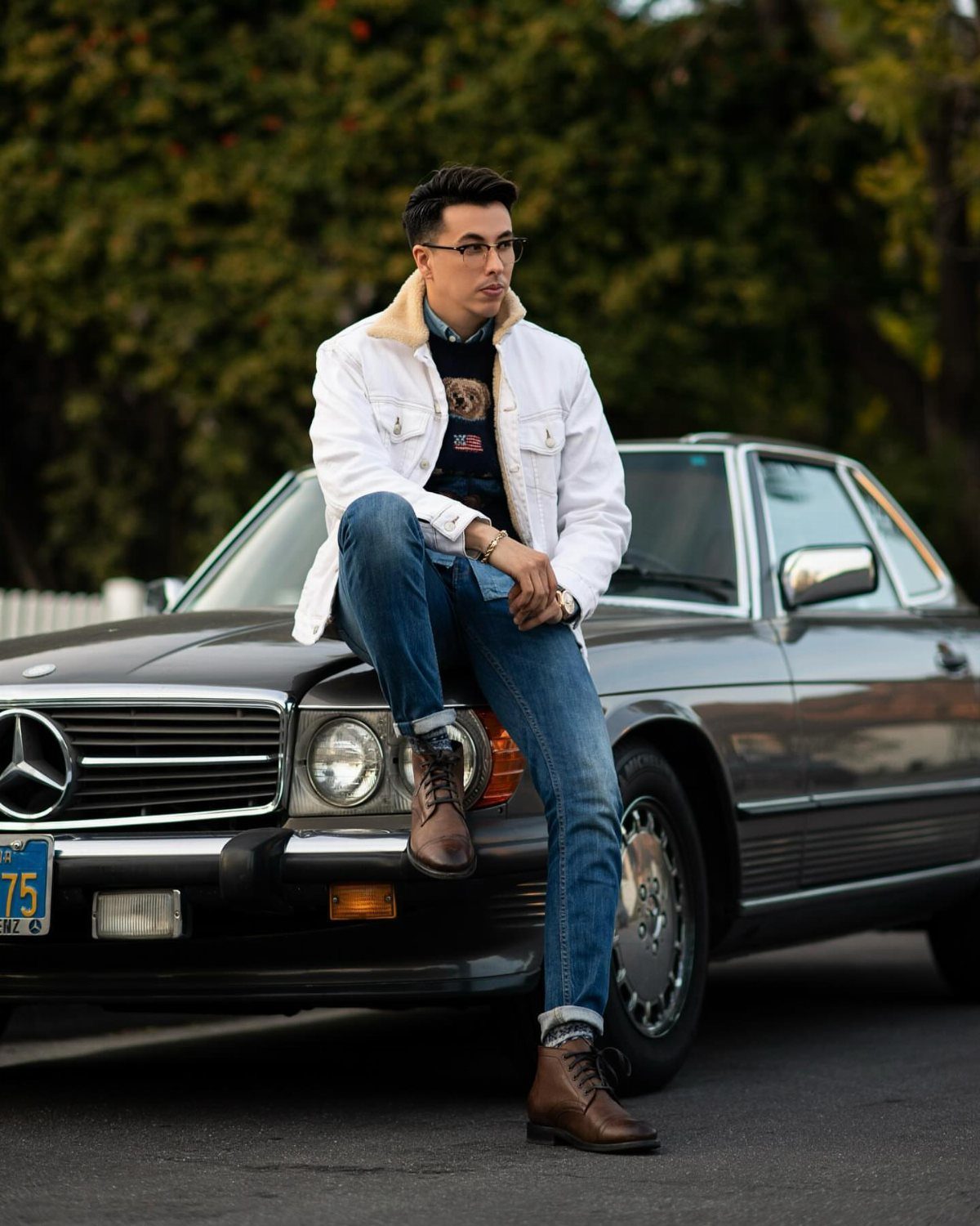 Man in white jacket and jeans leaning on a vintage brown Mercedes-Benz car