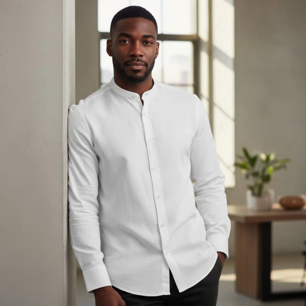 Man wearing a white long-sleeved shirt with a sleek mandarin collar.