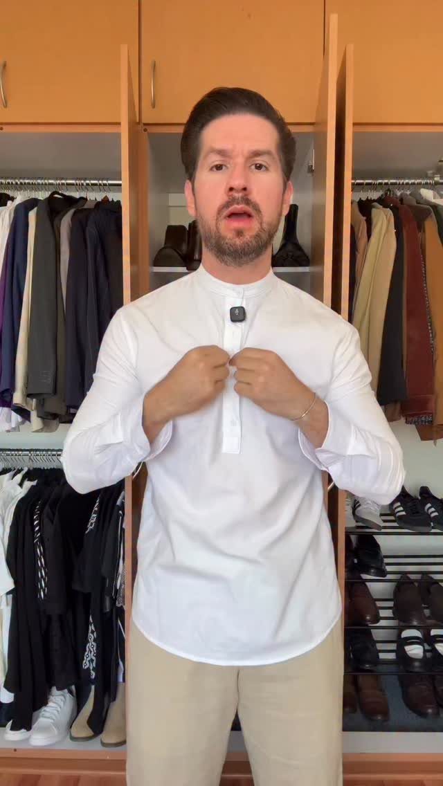 Man wearing a white shirt with a Mao collar and beige trousers.