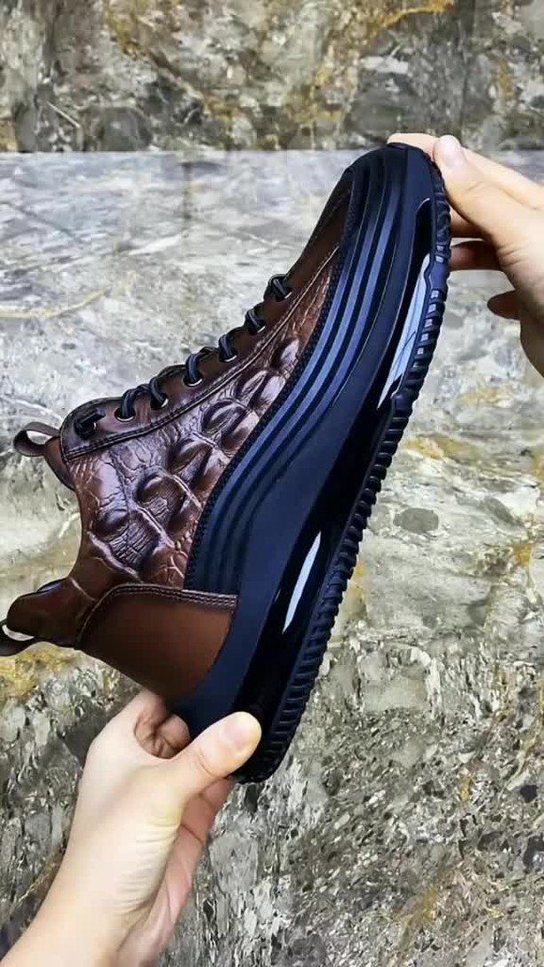 Brown crocodile-textured leather high-top sneakers with a thick black platform sole.
