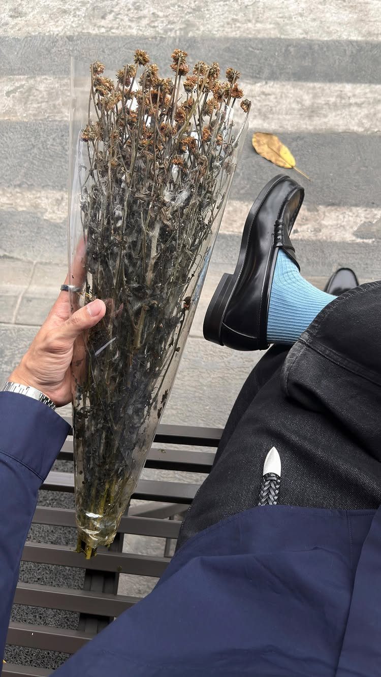 Light blue fashion socks worn with black loafers and black trousers.