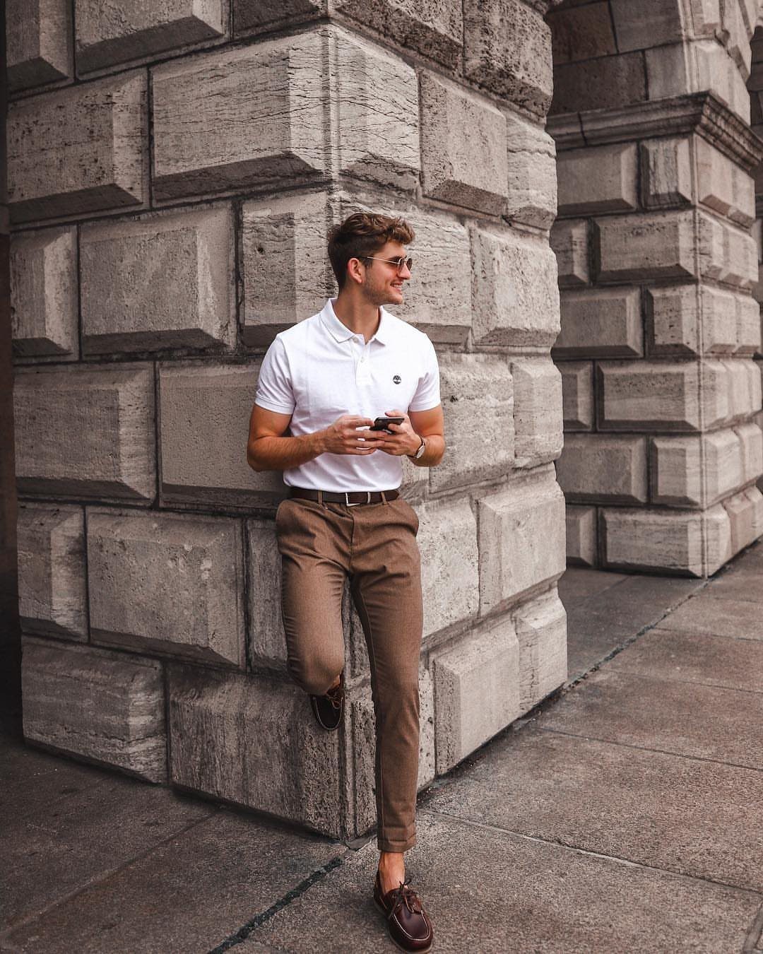 Man in white polo and brown chinos wearing brown leather boat shoes.
