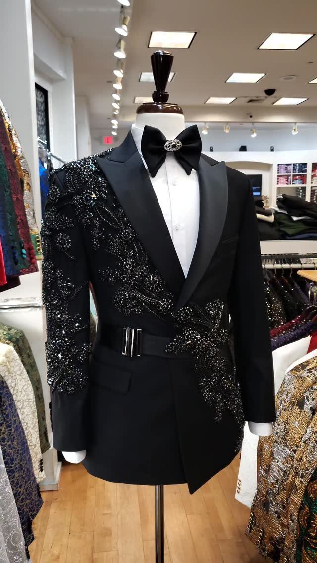 Black tuxedo on a mannequin with intricate black sequin embroidery and a bow tie.