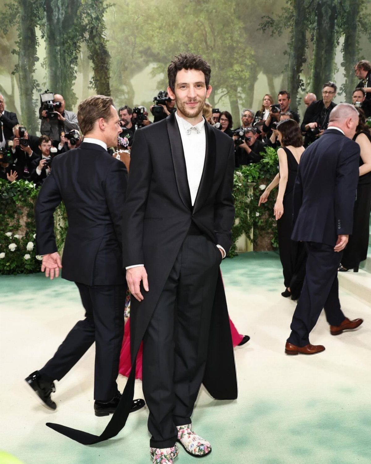 Josh O'Connor in a black tuxedo with floral shoes at the Met Gala.