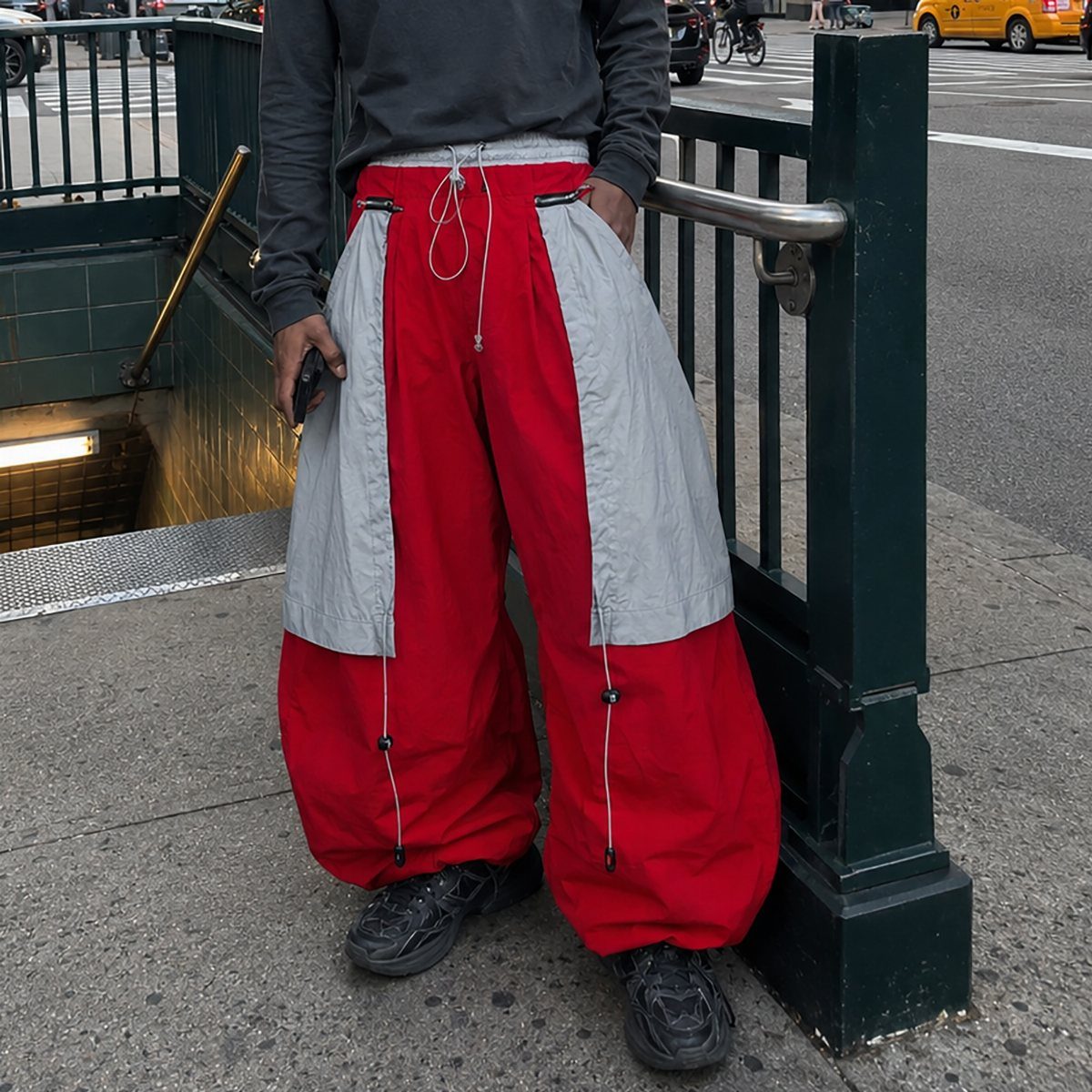 New Men's Fashion Pants: 12 Styles to Refresh Your Wardrobe 6 Baggy red and grey parachute pants with drawstring waist and adjustable ankle toggles.