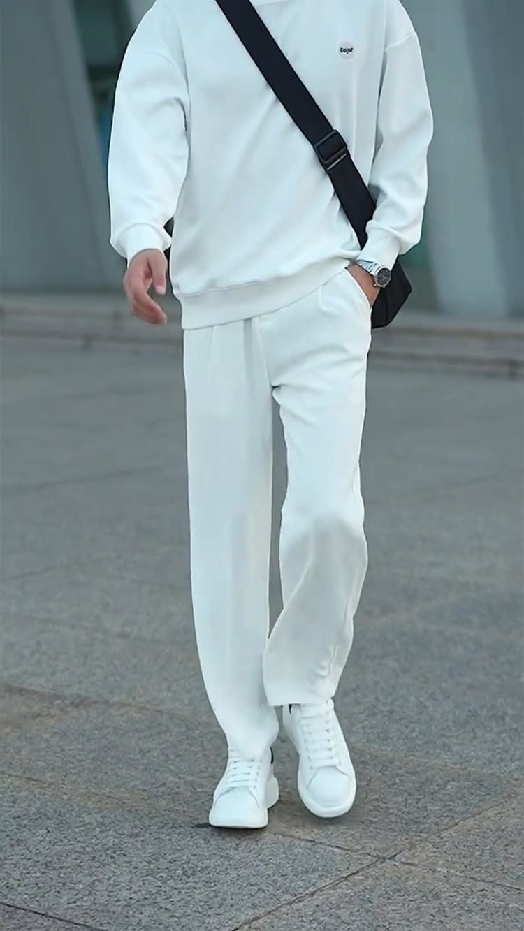 New Men's Fashion Pants: 12 Styles to Refresh Your Wardrobe 3 Man wearing white wide leg pants, white sweatshirt, and white sneakers.