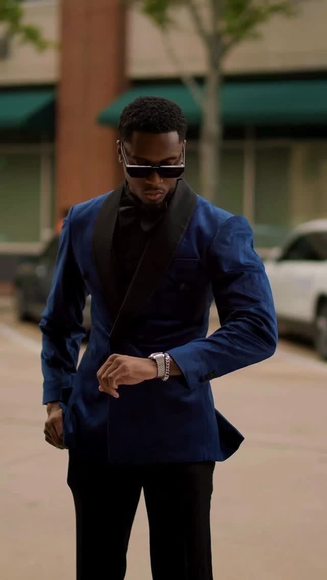 Man in a navy blue tuxedo with black lapels and a black bowtie.