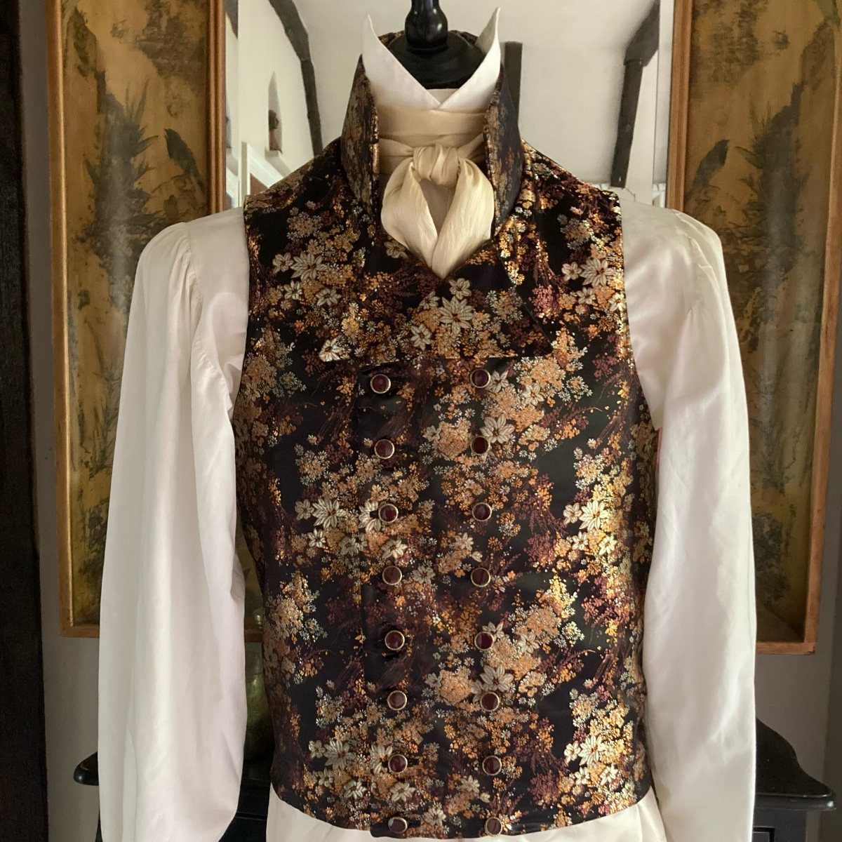 Floral patterned regency waistcoat worn over a white shirt and cream cravat.