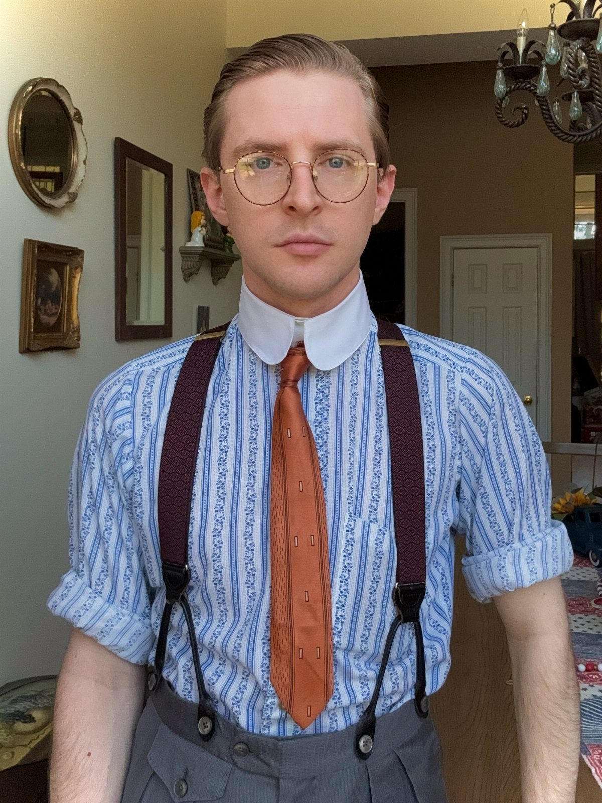 Man wearing a blue striped shirt with a white detachable collar and brown tie.